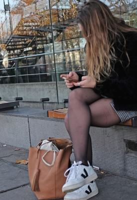 French student in pantyhose waiting for the bus