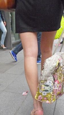 Candid in the street in skirt and high heels shoes