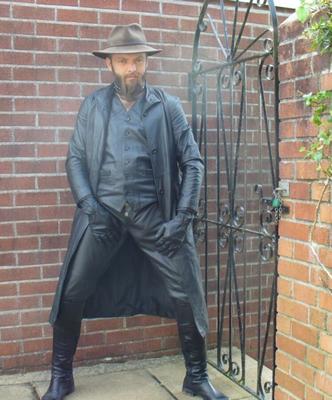 Leather master in long coat and boots