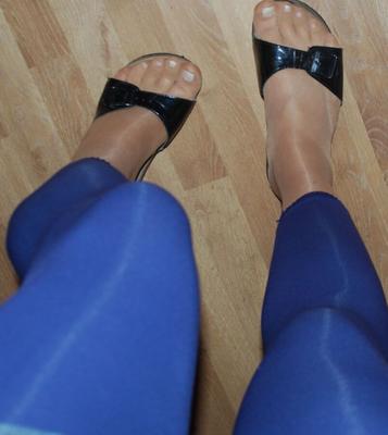 Shiny hosiery under blue leggings