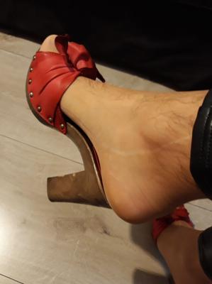 Leather black leggings and red sandals