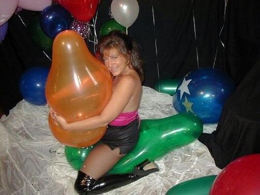 Voluptuous Woman Popping Balloons