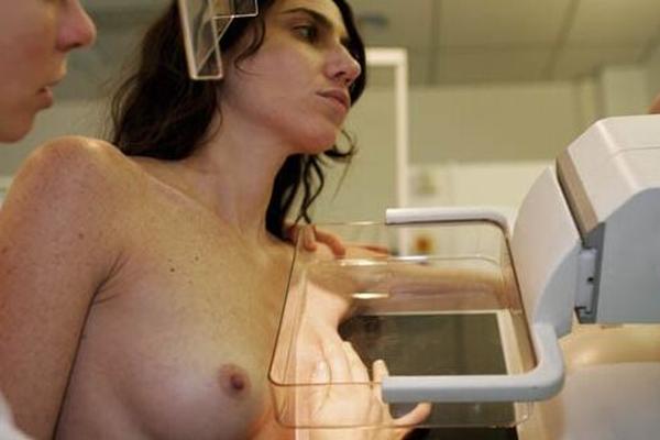 Young black-haired French Woman having a Mammogram