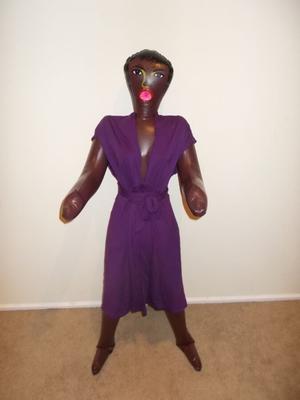 Black love doll wears purple dress