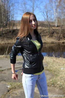 Handcuffed girl in leather