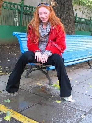 Young mature redhead pulls down trousers and pisses on the stree