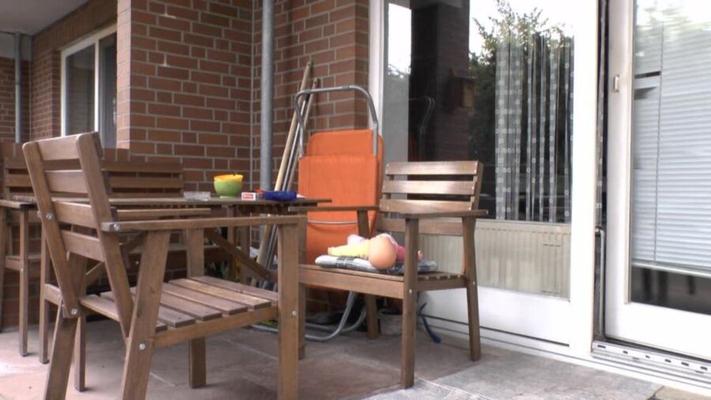 She enjoys her cigarette and coffee - and is seated on a doll