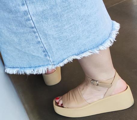 Woman in leather sandals with chubby toes