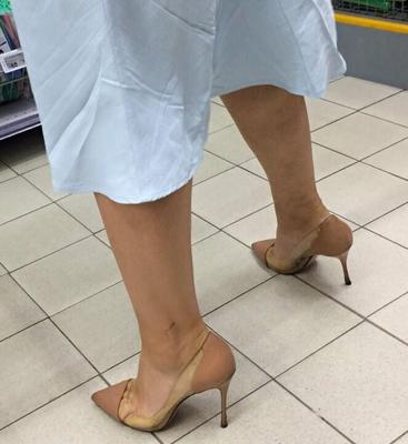 Woman in clear/nude heels in supermarket